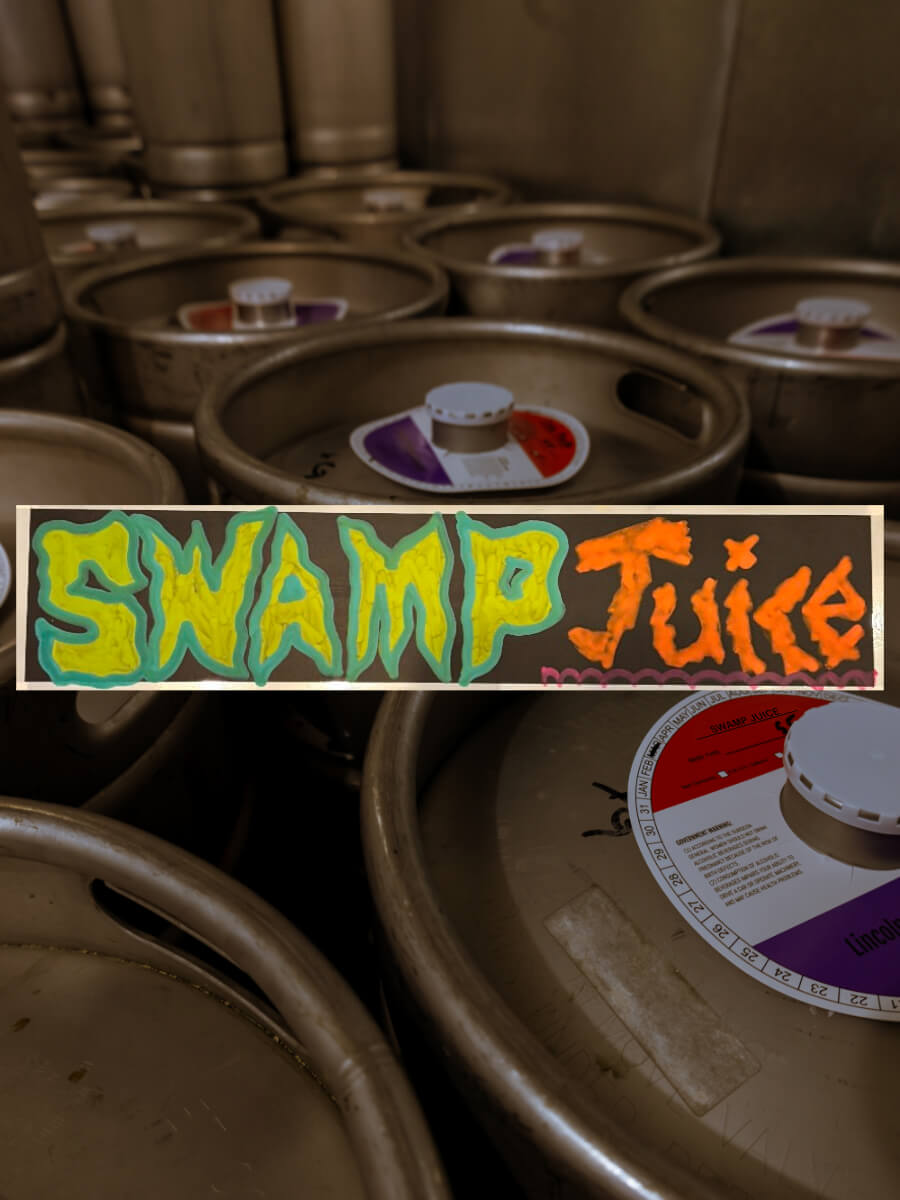 Kegs full of a porter beer named Swamp Juice.